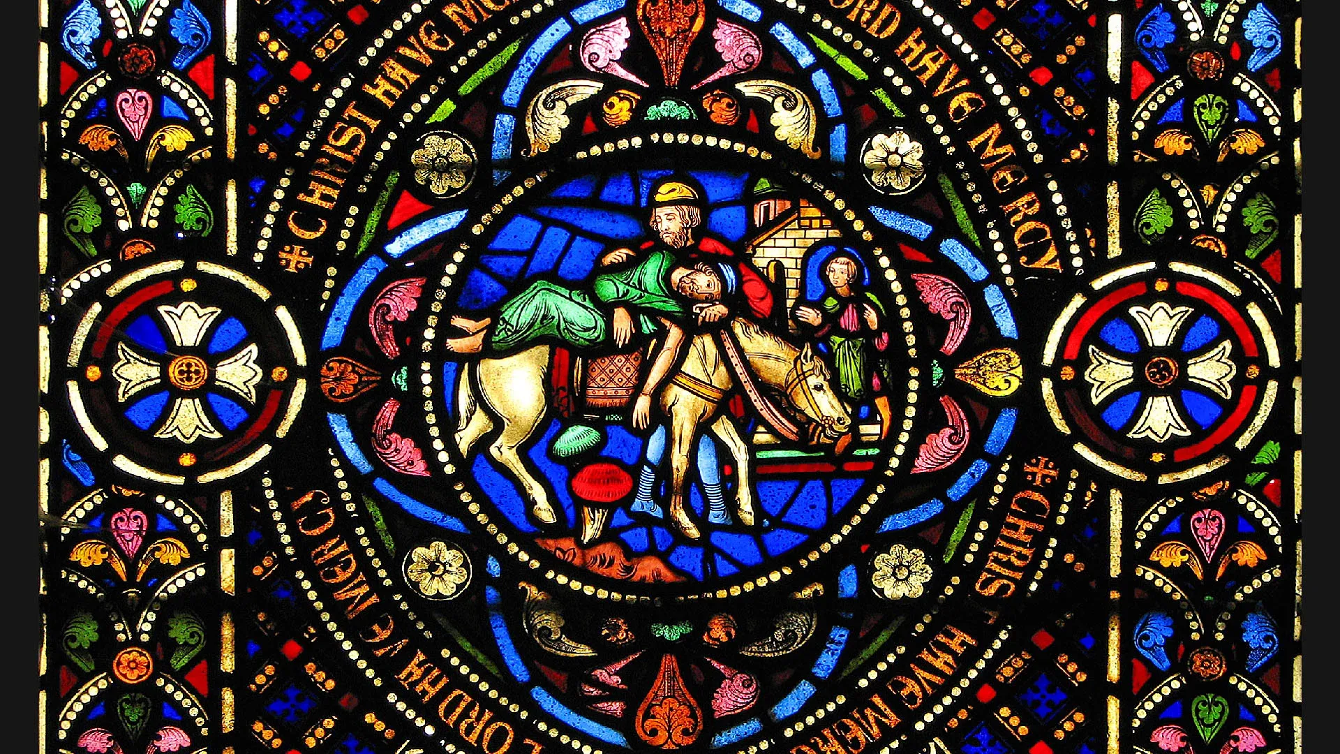 Le bon Samaritain. Détail d'un vitrail de l'église de Pusey, France.